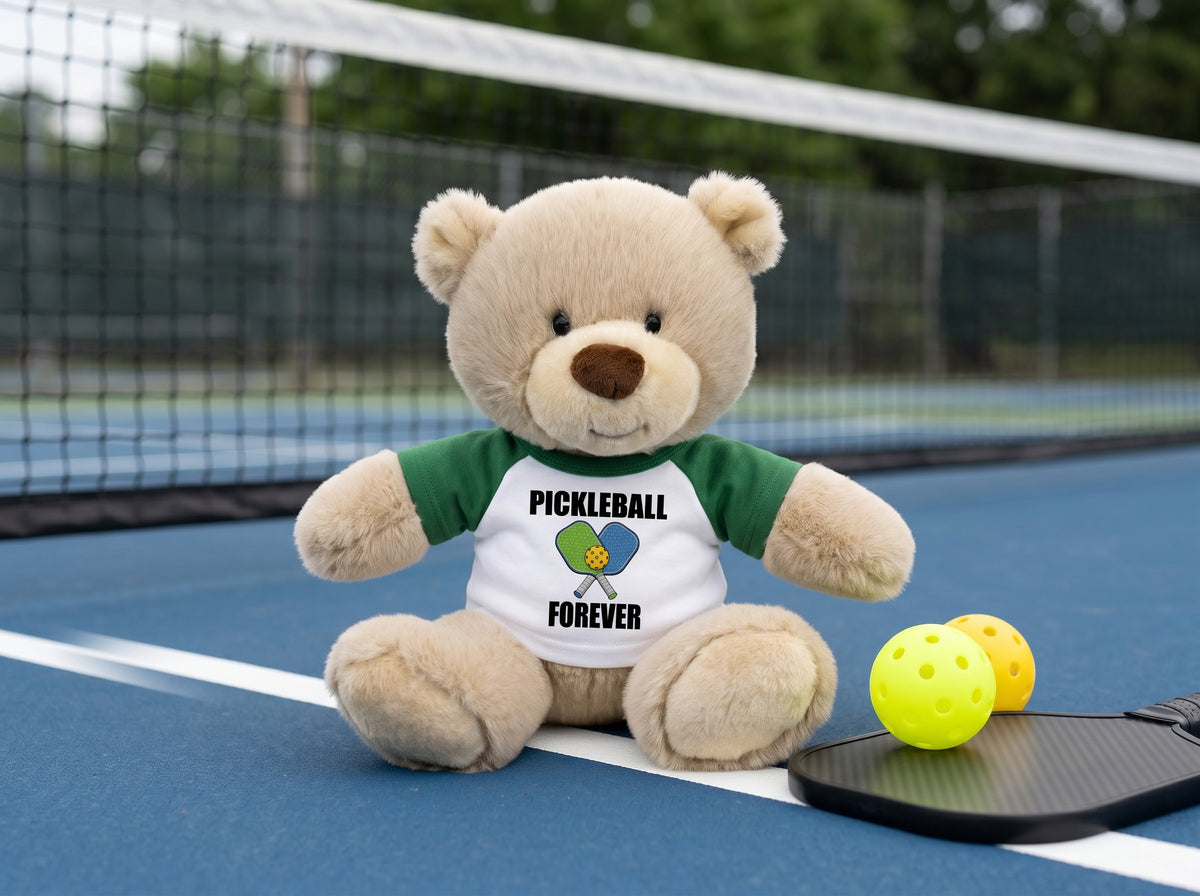 Pickleball Teddy Bear - Personalized 10" Tan Nuzzles Bear, Paddle Design - green sleeves, pictured on pickleball court. Perfect gift for pickleball lovers
